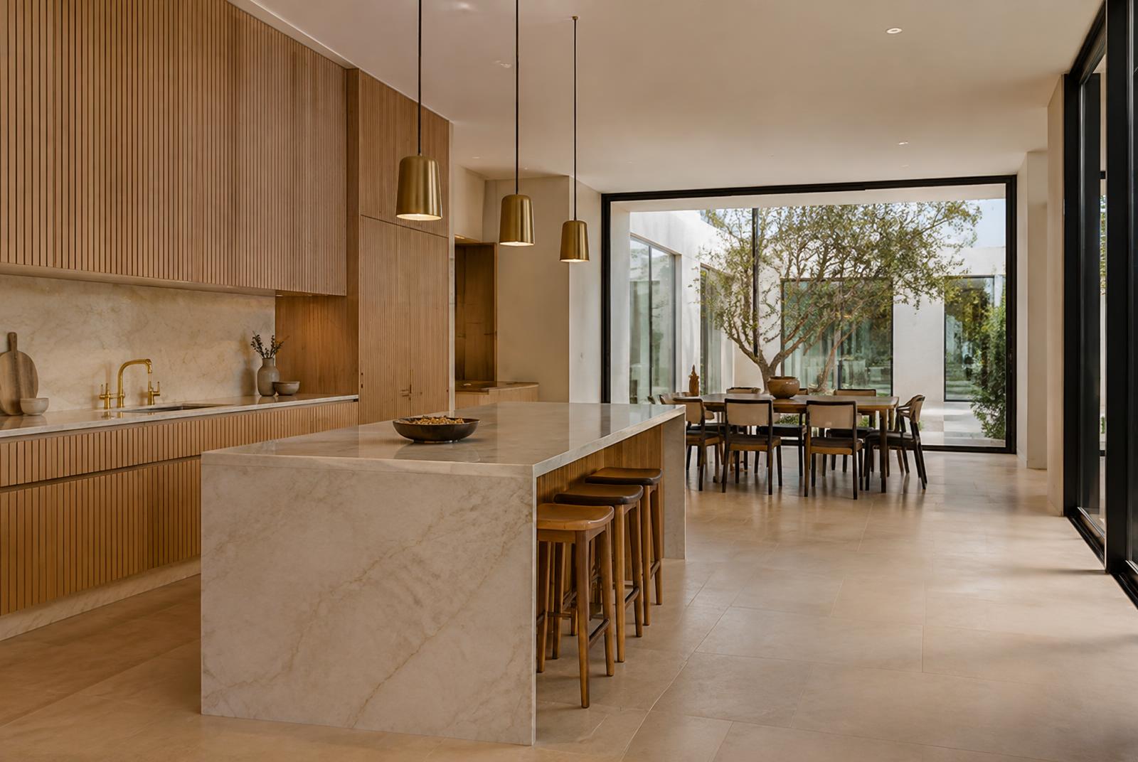 Kitchen with a marble island and fluted oak cabinetry